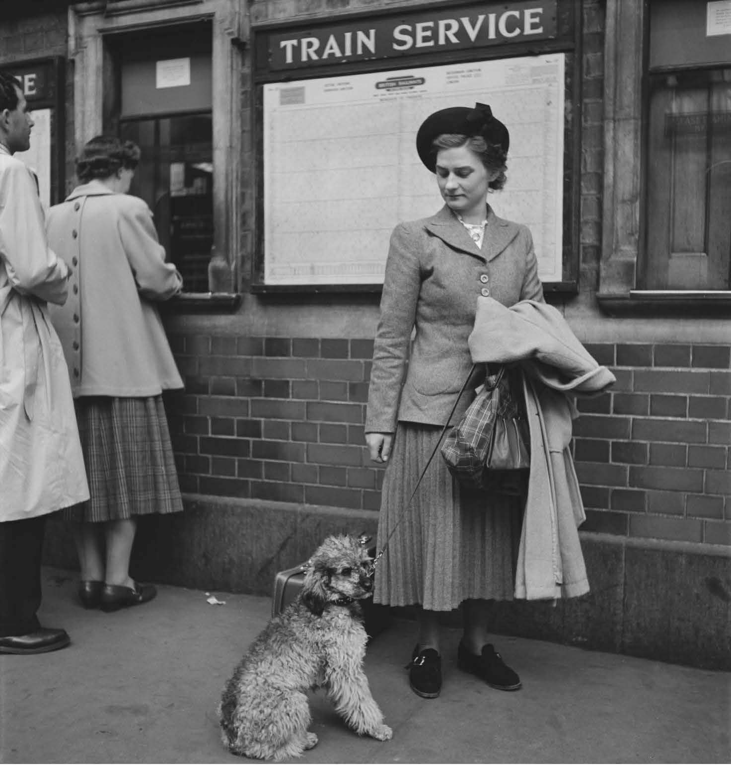 Lady with her dog at London Victoria station, 1950.