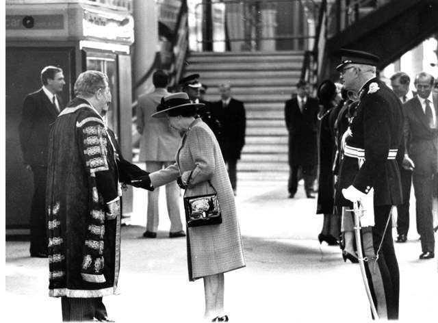 Reginald, on the left in his mayoral robes greets the Queen. 