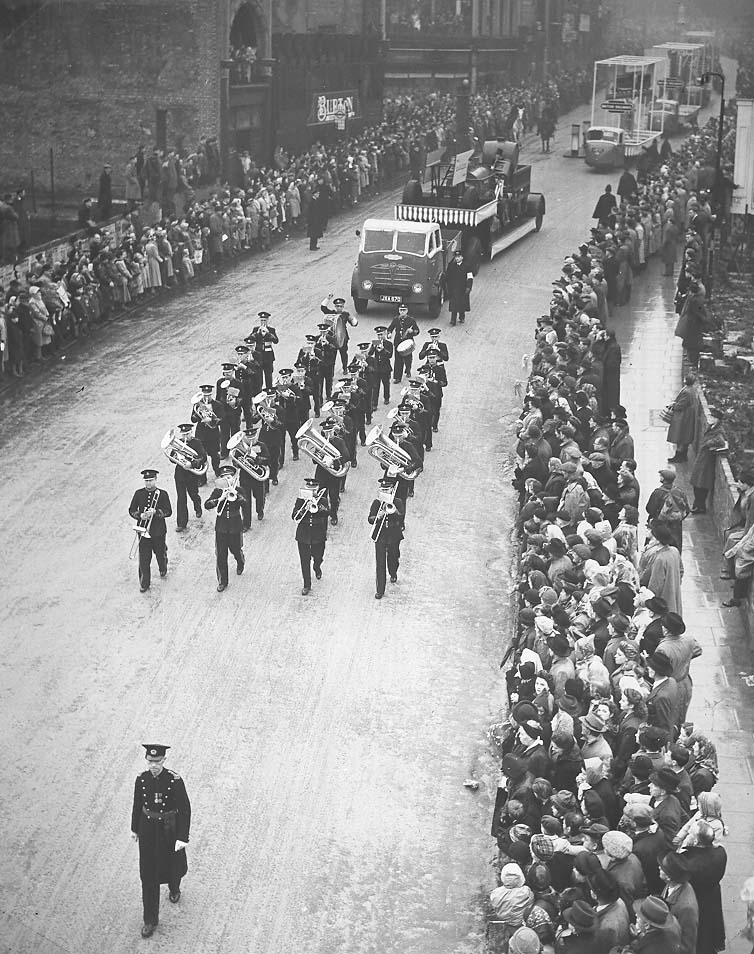 In this picture the band are shown at the end of their journey, marching through the wet streets of London in the Lord Mayor’s parade.