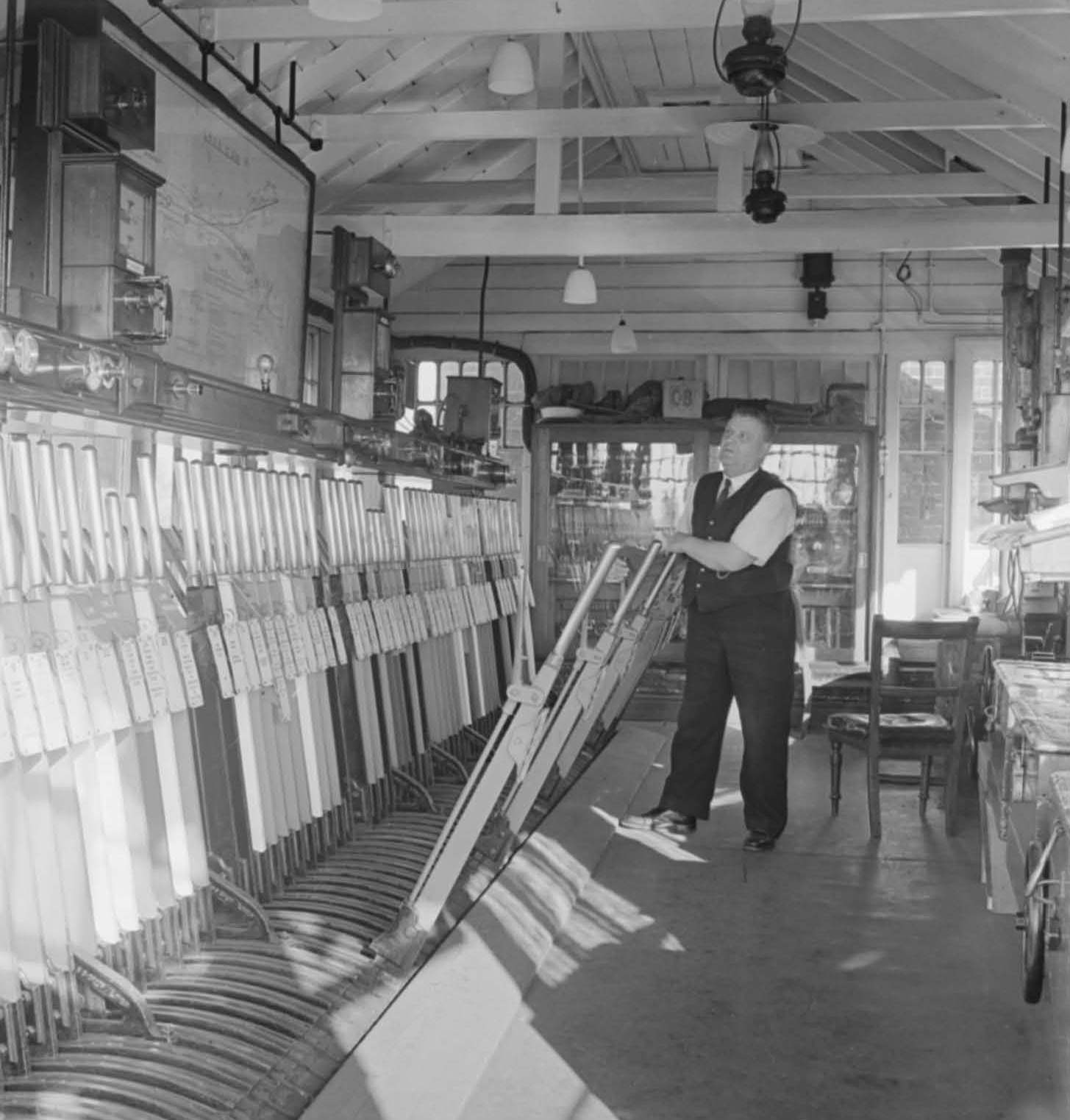 A signalman operating the levers in a British Railways signal box.
