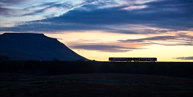 Heading for the Viaduct, Robert France A Northern Rail Sprinter passes Ingleborough and heads towards Ribblehead Viaduct at sunset in late November. I’d intended to take some silhouettes of the viaduct but as I was setting up my tripod the train approached, and I took a few shots of it running towards the viaduct. It wasn’t the shot I’d originally intended to take but it is much better than the rest.