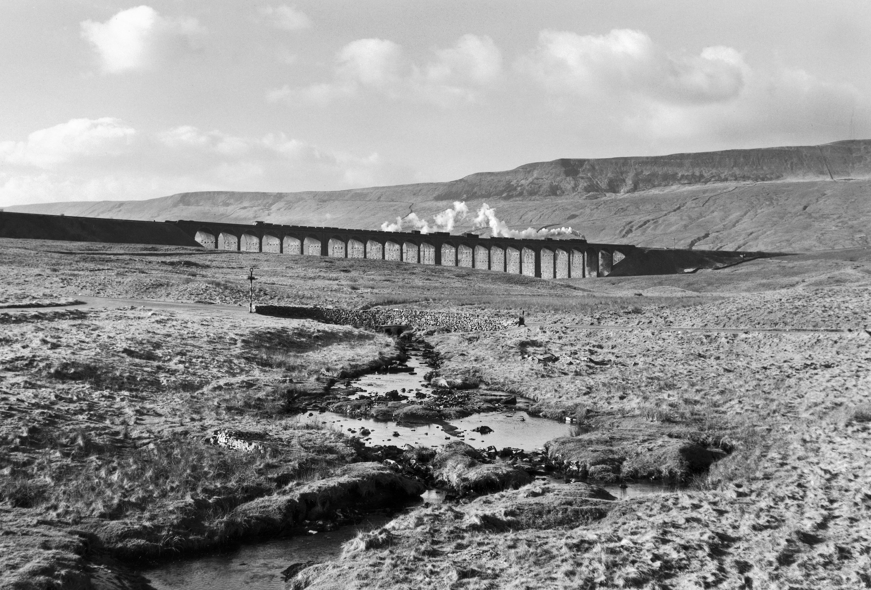 Ribblehead Viaduct on the Settle & Carlisle Railway is an iconic railway structure. Here, Eric Treacy captures a goods train on the viaduct