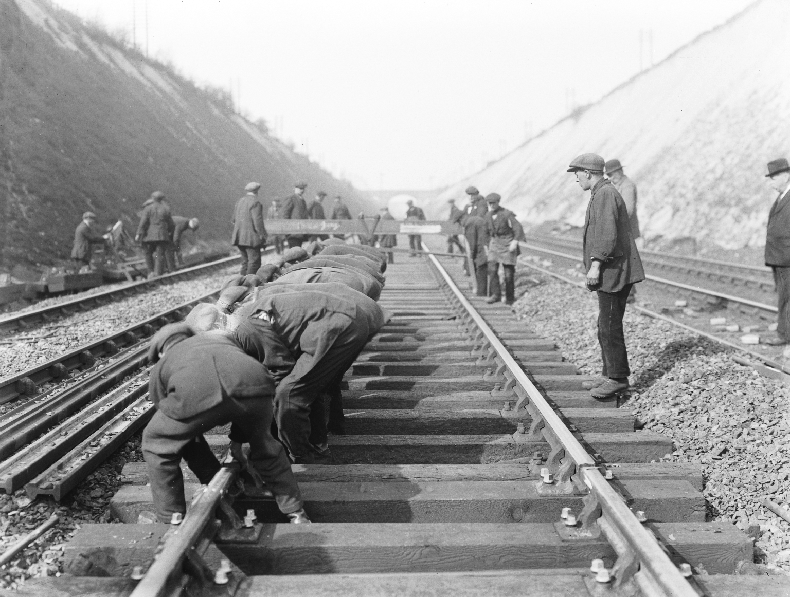 Permanent way workers laying new rail, 1923. 