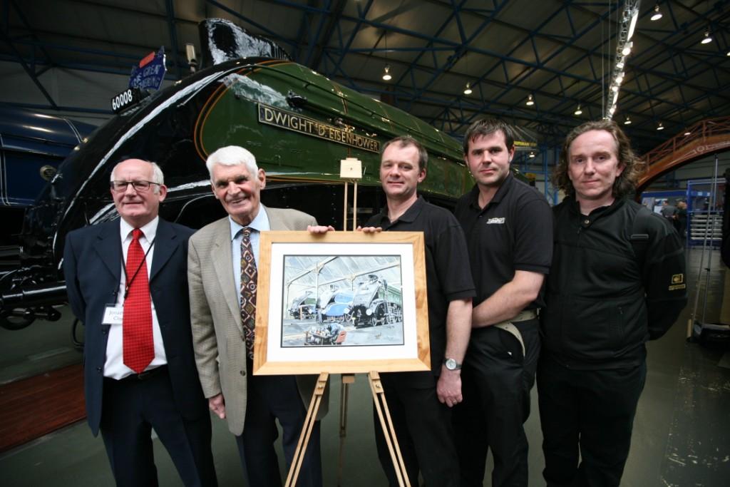 The Heritage Painting team in front of Dwight with a specially commissioned piece of art celebrating the A4s.