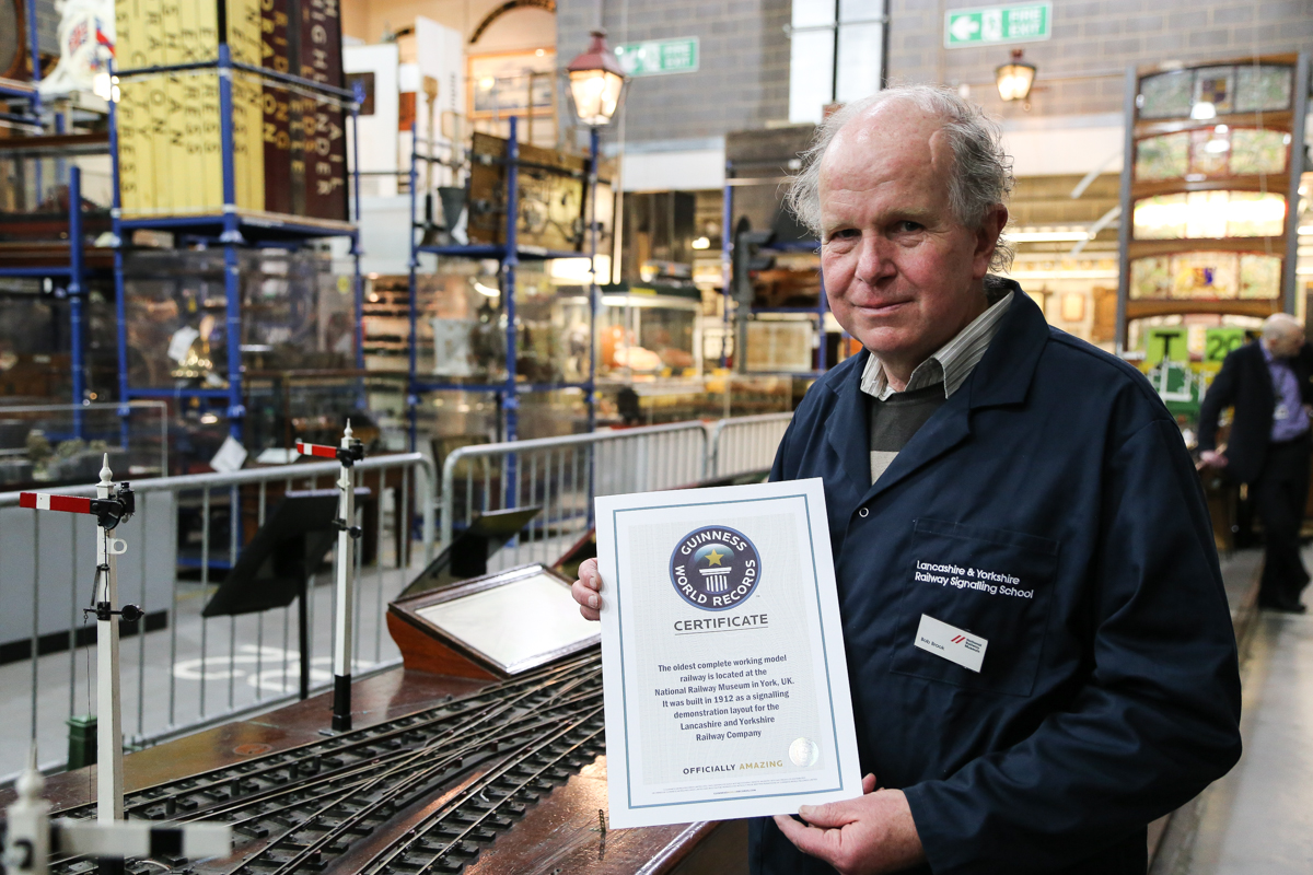 Bob Brook (NRM Volunteer) holds the world record certificate 