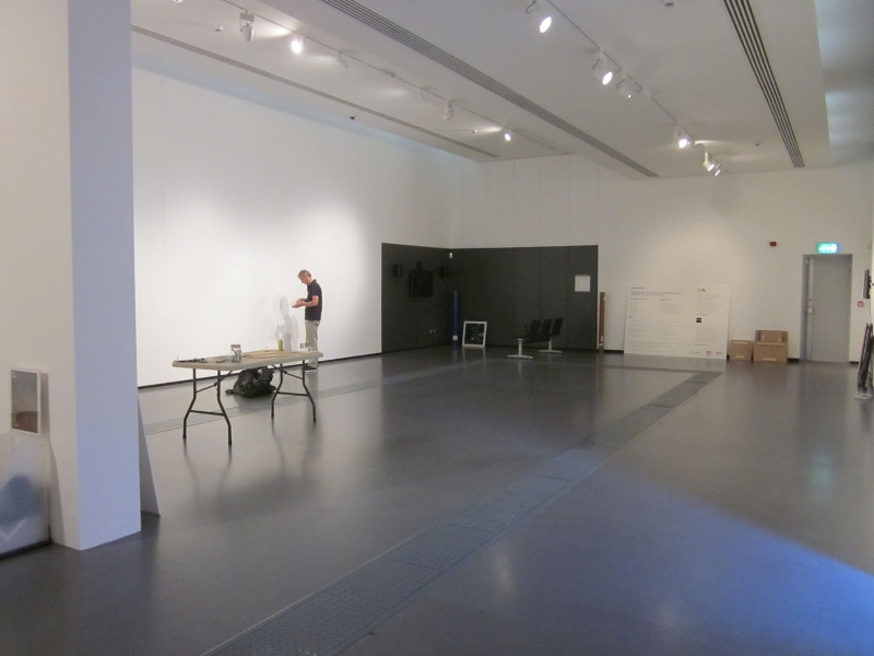 Joe looks very small in the empty Gallery filling holes.