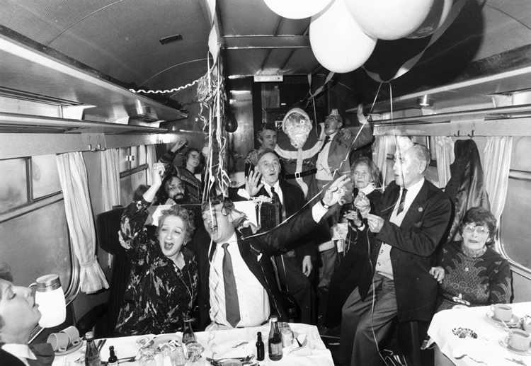 Christmas party on board a train, December 1985. (Img Ref: 10465805). Quite possibly after a little too much British Rail Claret.
