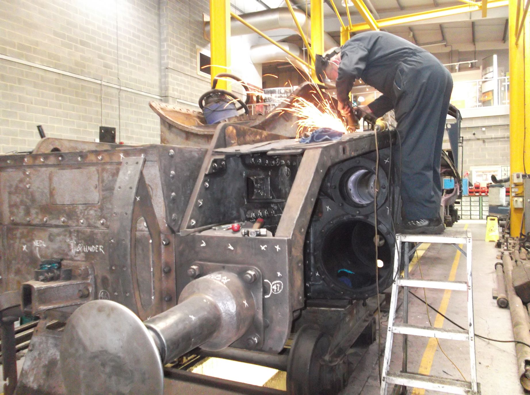 Bob Shearman cutting the footplating above the left hand cylinder to allow access to change a bolt.