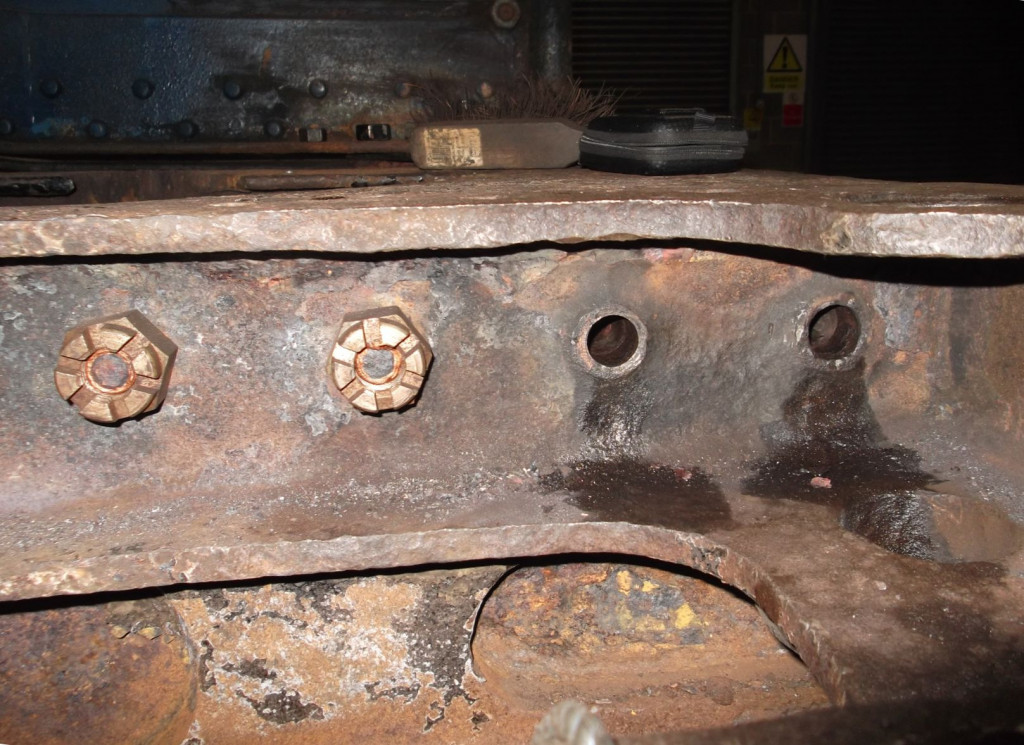 The holes where the old dragbox bolts were removed are being cleaned up to prepare for the fitting of new bolts