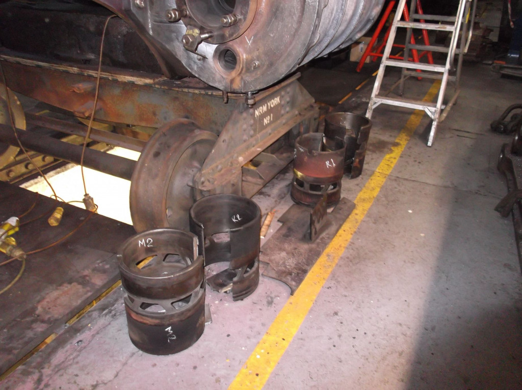 The removed valve liners from middle and right-hand steam chests lined up next to the right-hand cylinder.