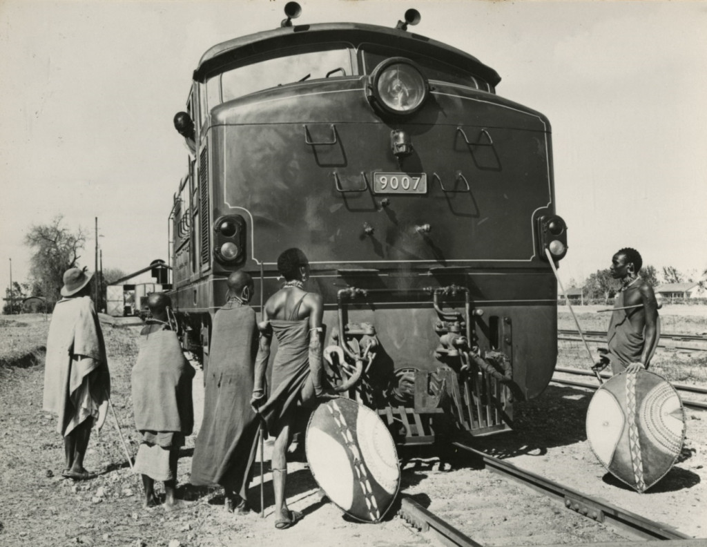 Masai tribesmen inspect an English Electric-AEI Class 90 diesel electric loco, East African Railways, 1960, photograph. (Ref: GEC/4/5/12)