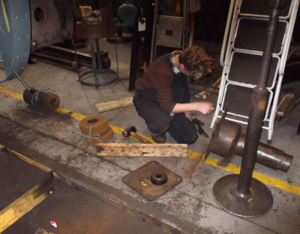 A member of the "007 Gang", our Junior Volunteers, with the components that make up the buffers that they had just removed.