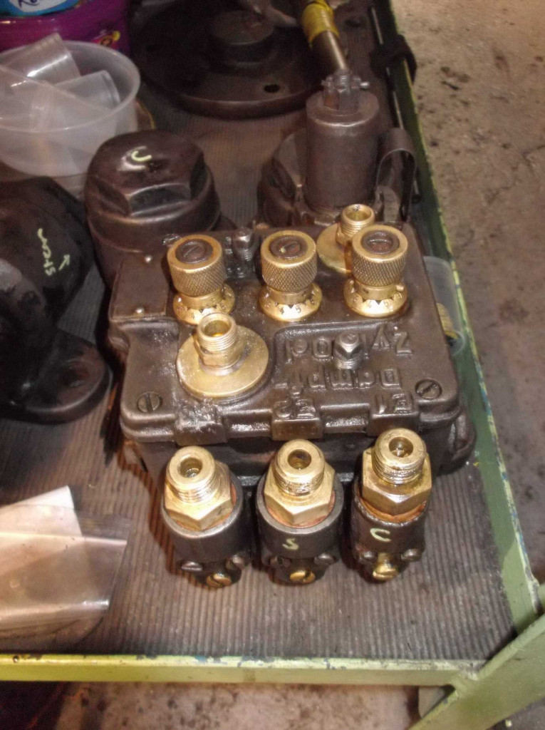 The air pump lubricator removed from the air pump. The lubricator comprises three pumps. One pumps steam oil to the steam cylinder, air oil to the air compressor cylinders and to the piston rod glands.