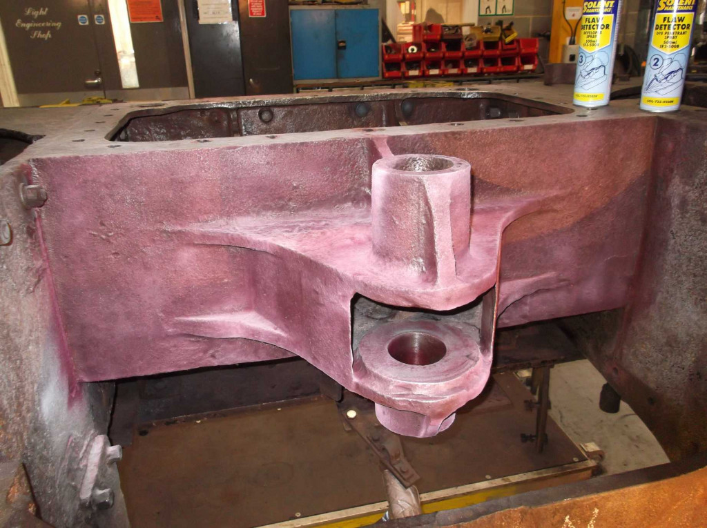 The front of the dragbox during di-pen inspection. The holes where the main drawbar pin goes through the casting can be seen.