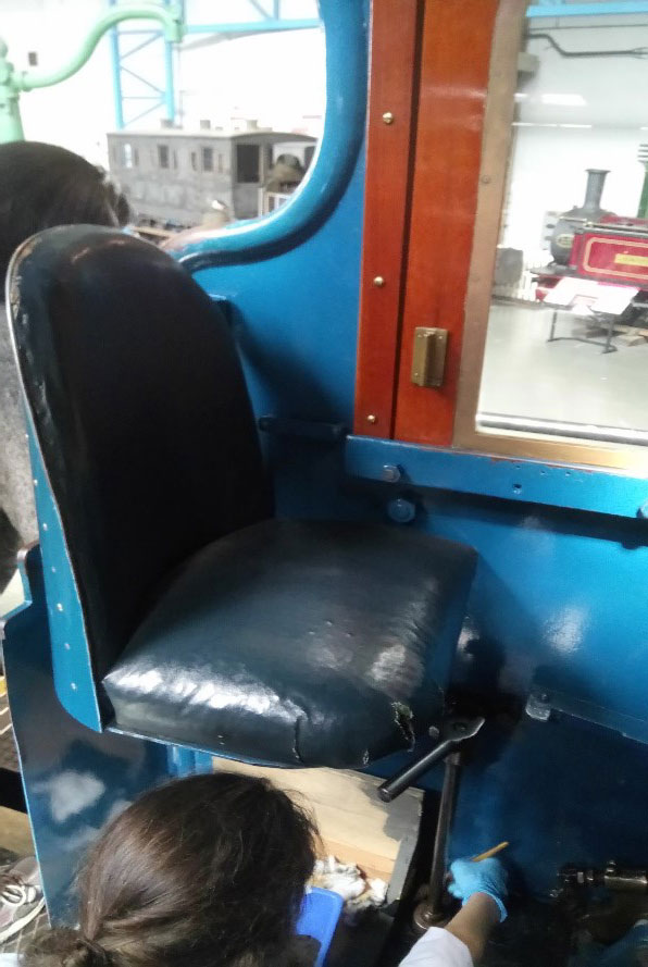 Conservator check the condition of the seats in Mallard's cab.