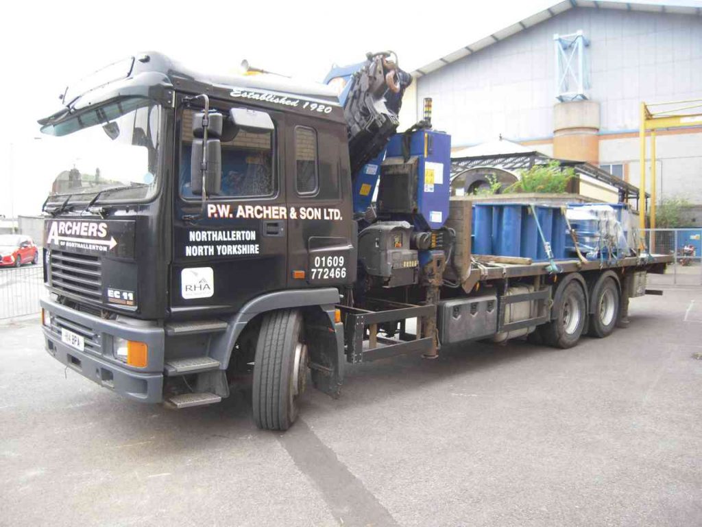 A flat-bed lorry loaded with lifting gear outside the National Railway Museum.