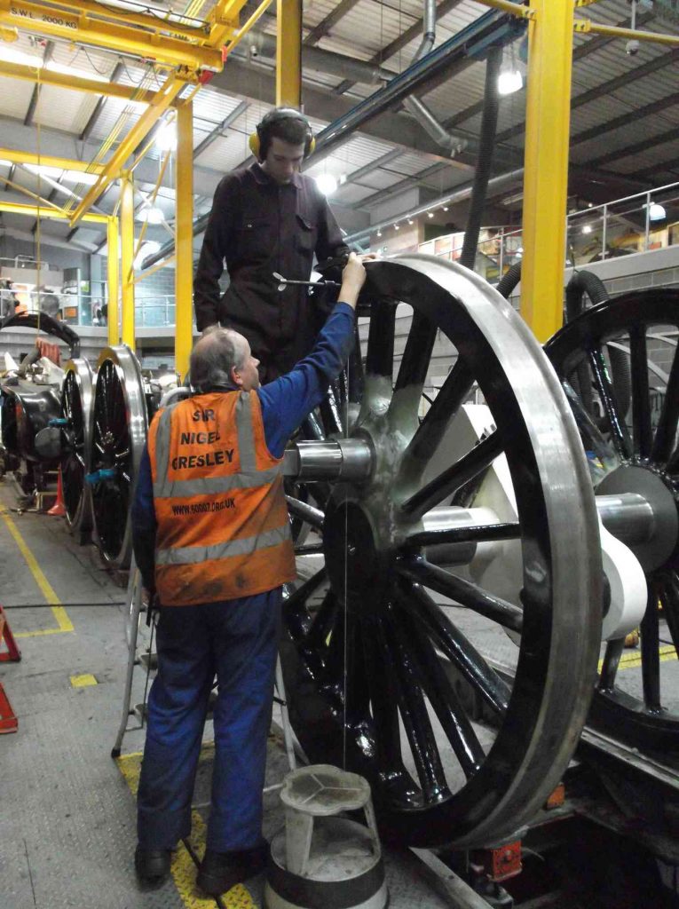 Measuring locomotive wheels in the workshop.