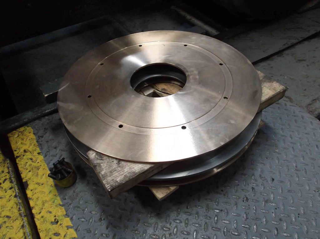 New bogie bearing discs on the workshop floor.