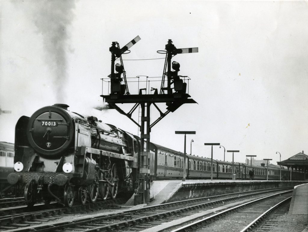 Oliver Cromwell hauling the 13.35 train to Liverpool Street leaving Norwich, 1957