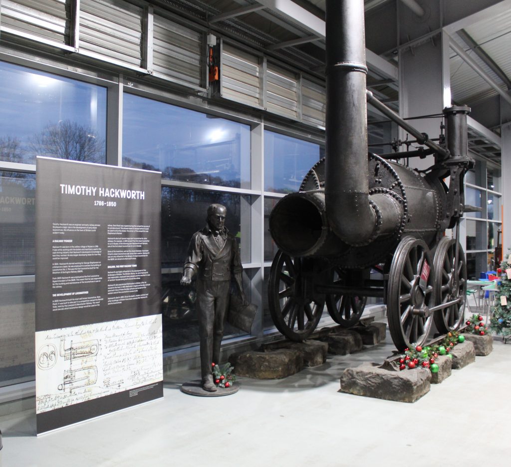 Locomotive Sans Pareil, a statue of Timothy Hackworth and interpretation panel at Locomotion