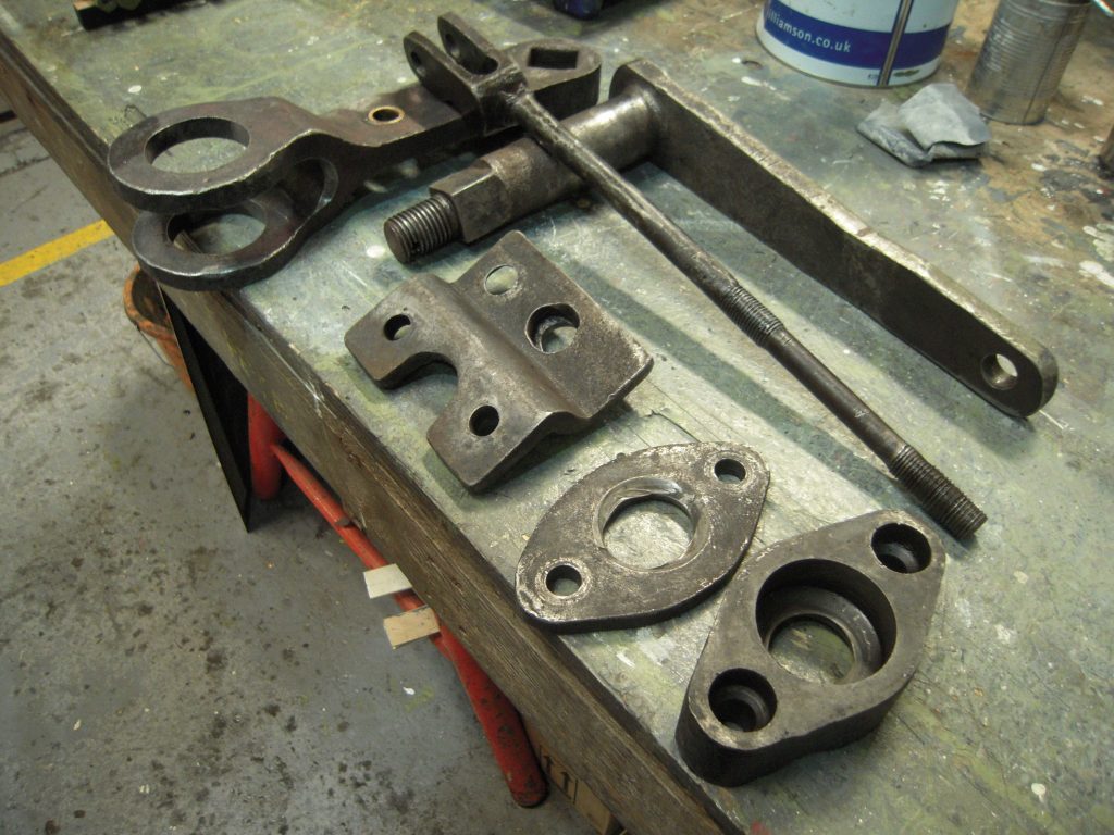 Components from the drop grate operating mechanism
