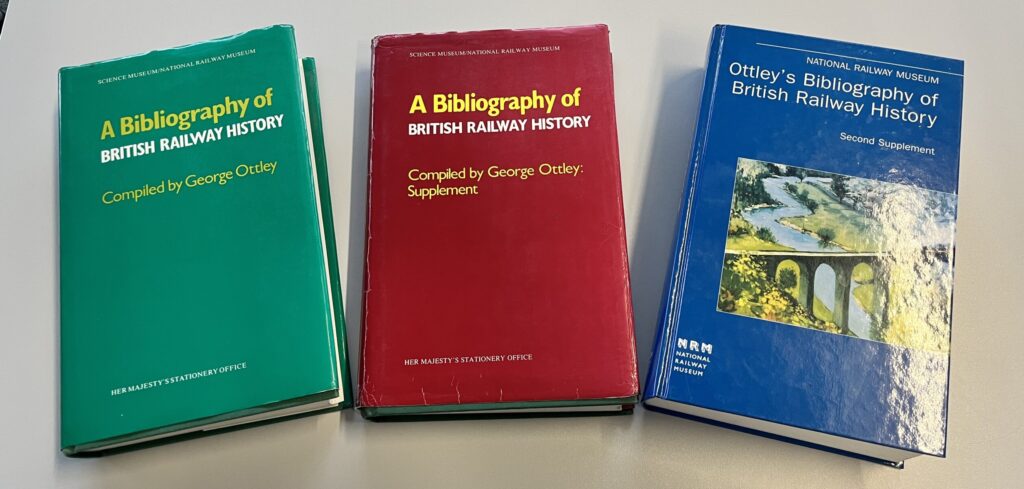 3 books on a table showing the different editions of Ottley's bibliography