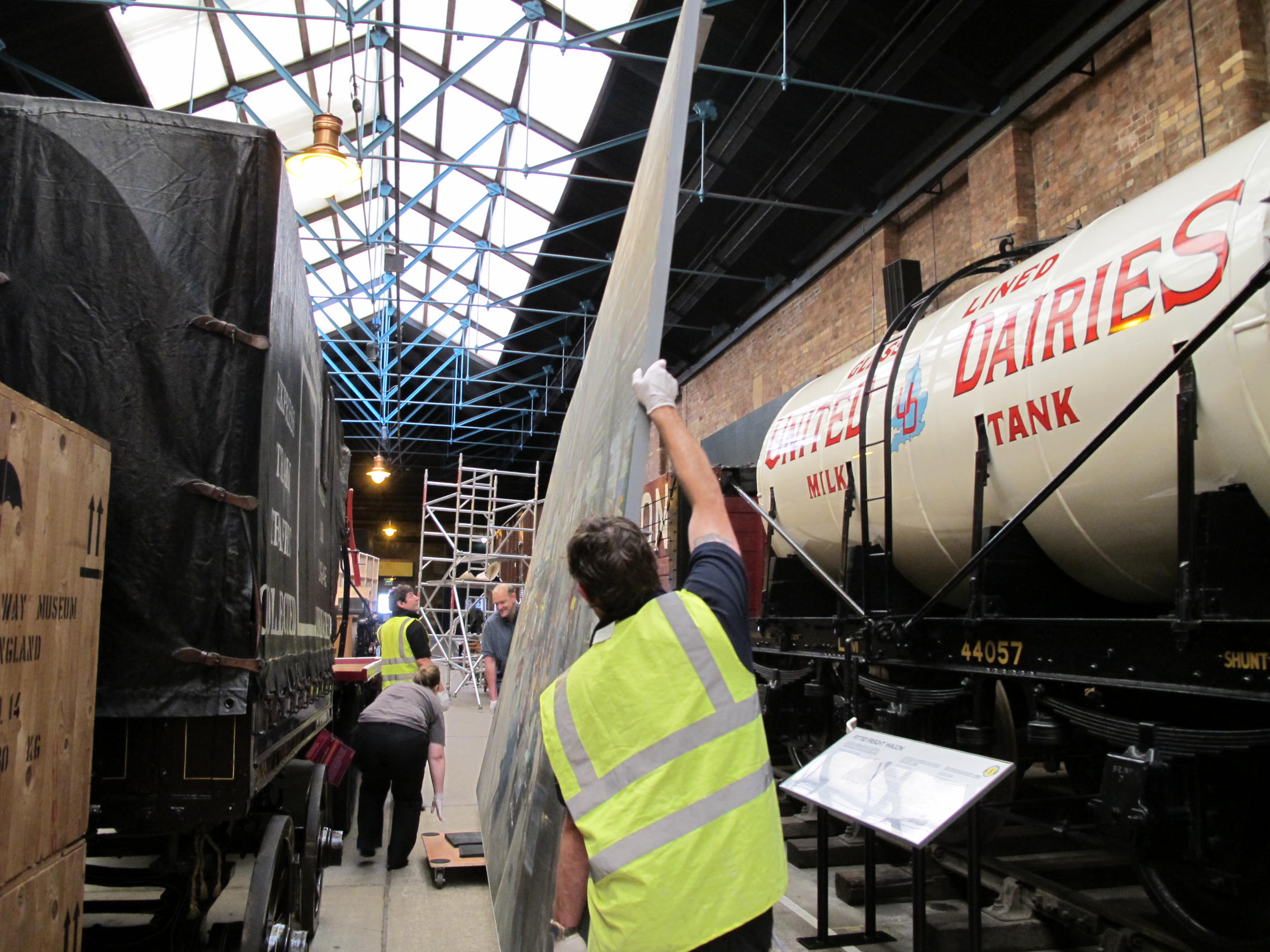 NRM staff move a large painting by Terence Cuneo through Station Hall