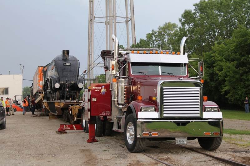 American wrecker firm on hand to assist with winching the loco onto the flat car