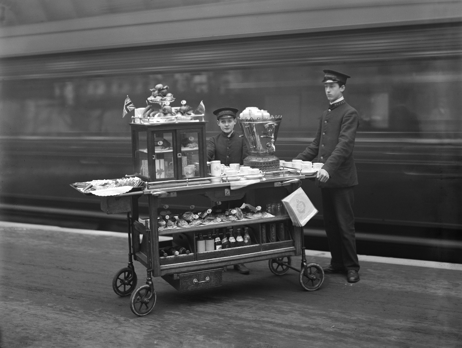 Young boys manning a refreshment trolley in Paddington station, 1910.