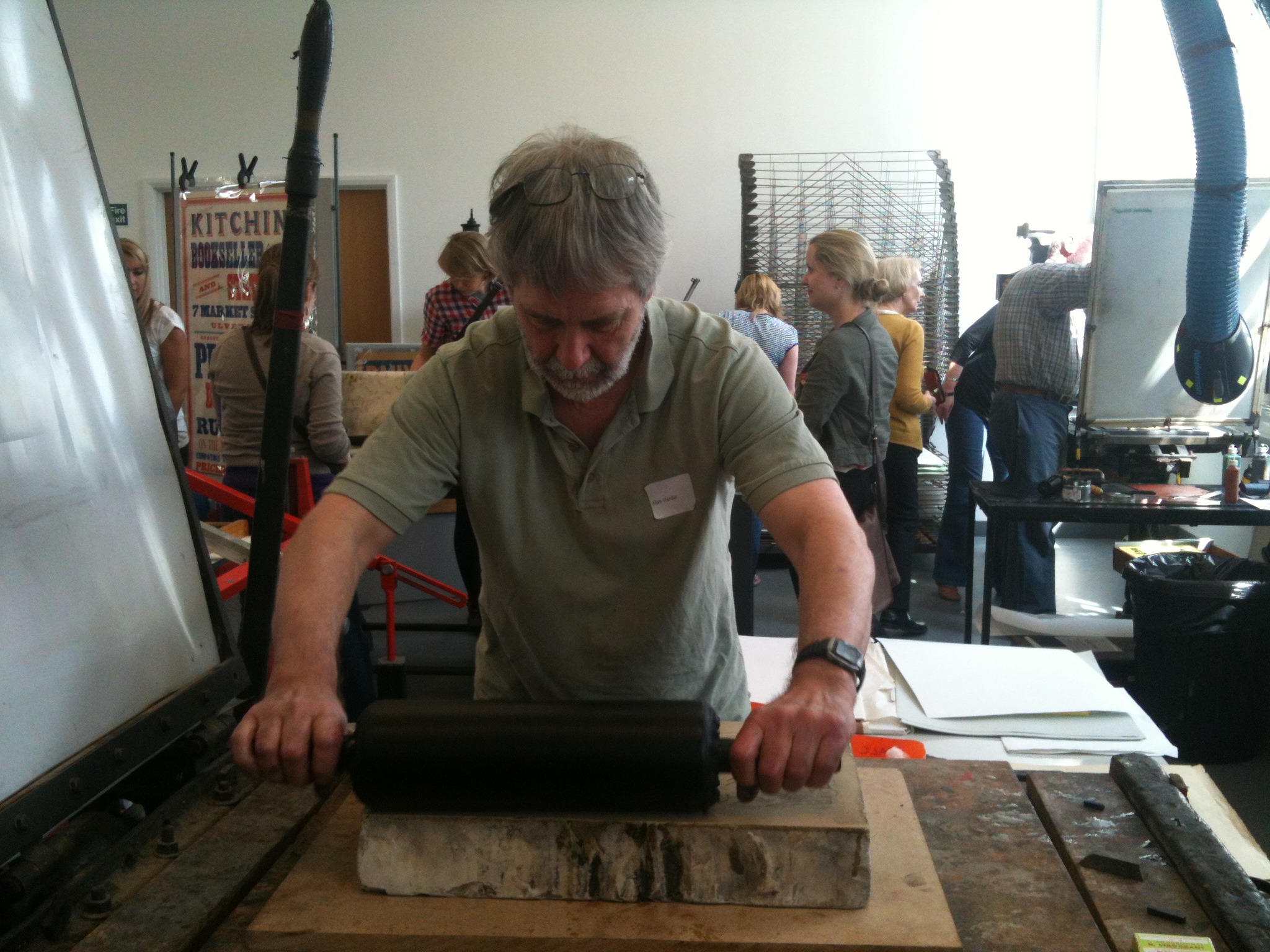 The stone is inked with a greasy ink that sticks to the design but not to the damp stone.