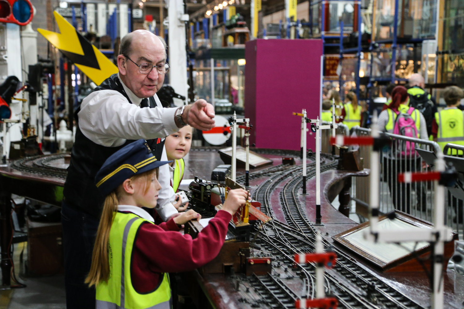 Volunteer Peter M Webster, helping Carr students signal trains