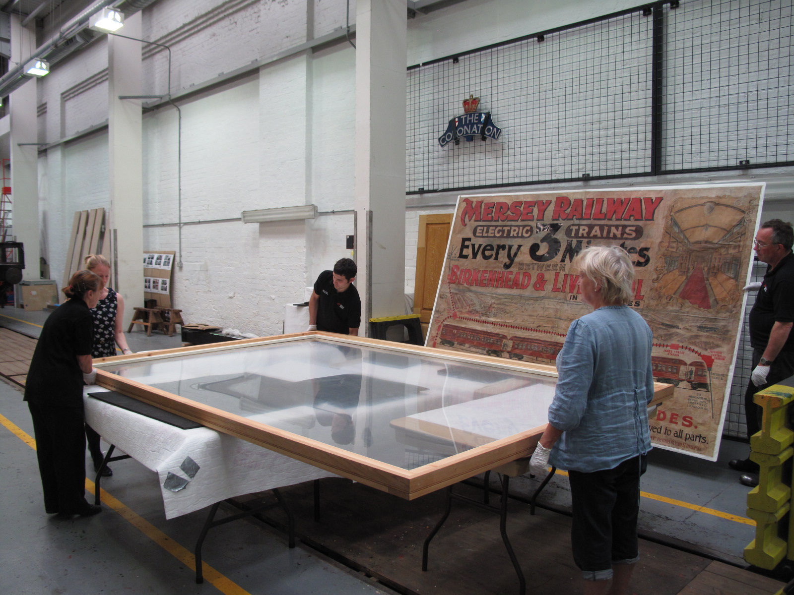 The frame was prepared and the poster careful lowered into it.