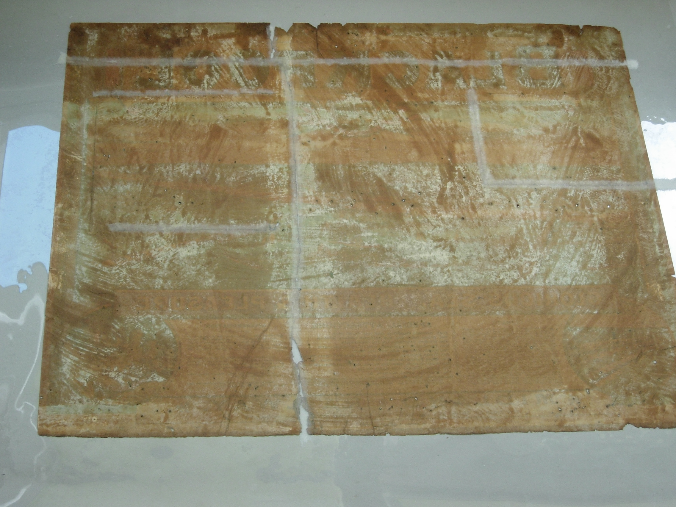 Blackpool poster, during conservation, repairing tears before lining