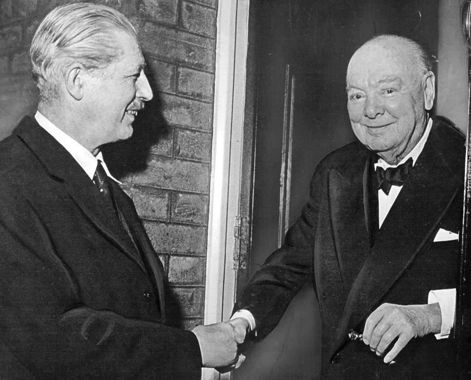 Sir Winston Churchill congratulating Harold MacMillan on his becoming Prime Minister in 1957. MacMillan acted as one of the twelve pawl bearers at Churchill's funeral.