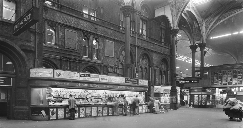 W H Smith's newsagents at Liverpool Street station, 23 June 1955.