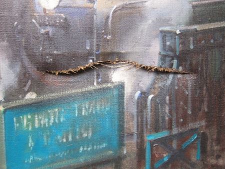 The tear in the painting, showing the distortion caused by the impact