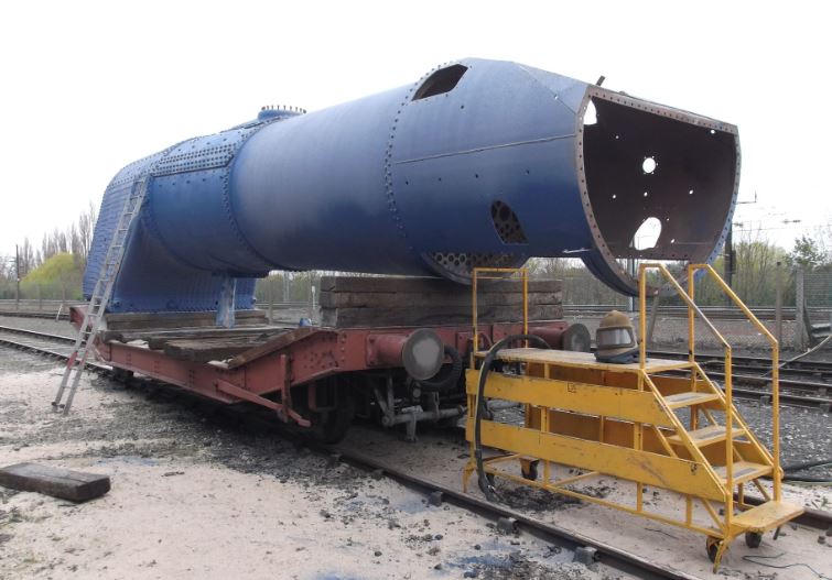 The outside of the boiler blasted and primed.