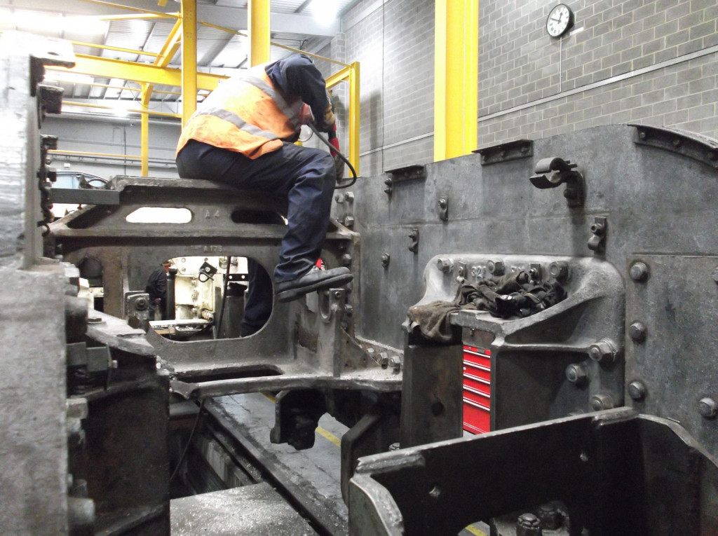 Taking his turn with the needle gun is Malcolm Hutton. He is sat on the frame stretcher that also provides support to the boiler. A view looking forward