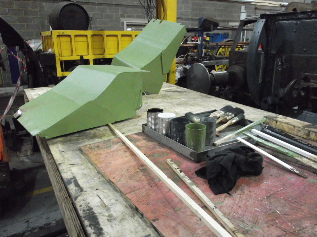 The painting bench has been turned to give more room in the workshop for locos over the wheel drop. The sand filler guards normally beneath the streamlining have been repaired and are now being painted.