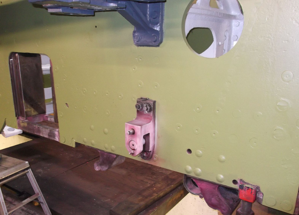 The brake hanger bracket during inspection. An isolated unpainted component