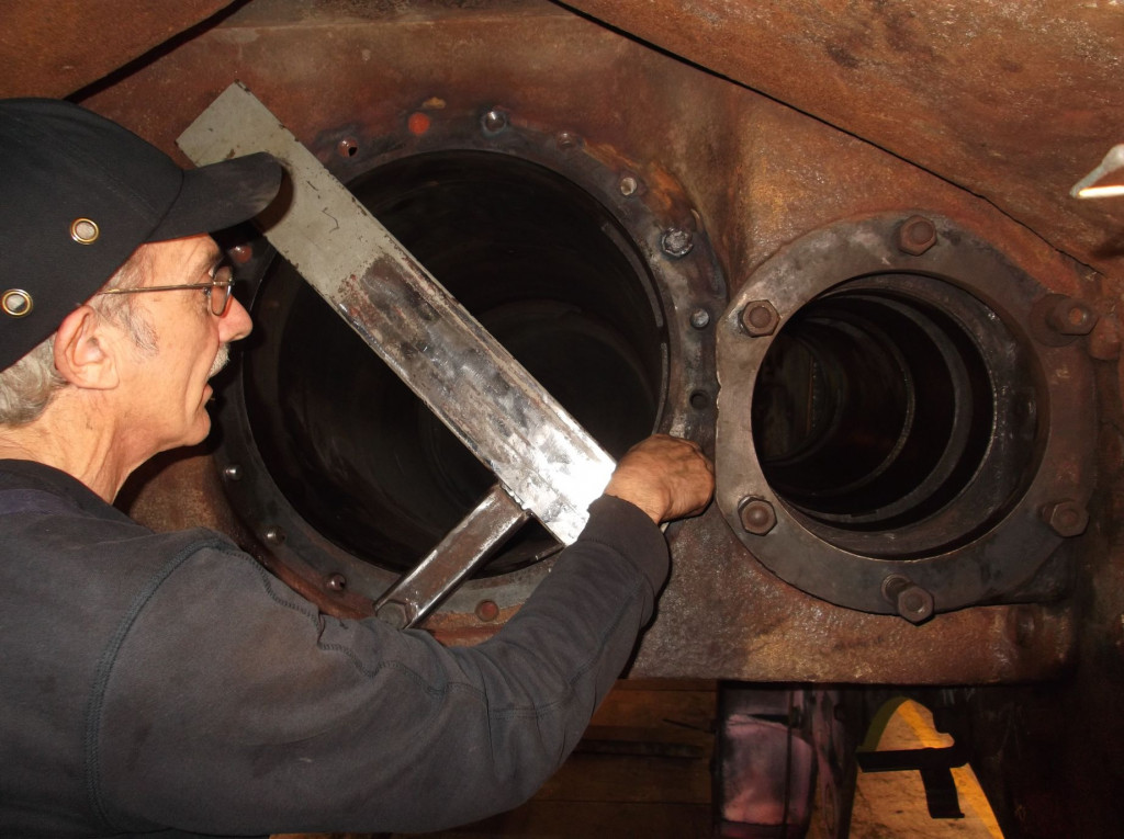The drilling jig used for removing the middle cylinder studs accurately worked first time. Tony Bickerstaffe who was responsible for its design and construction fastens it it place