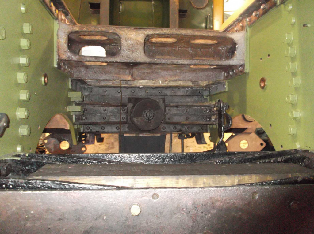 The front section of frames is now receiving primer. The vertical rows of nuts secure the leading flanges of the outside cylinders.