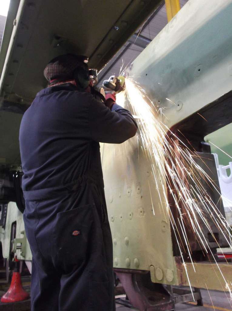 After fitting, the rivet heads are ground flush with the frames. Bob Shearman grinds the heads but the photo also shows how the footplating prevents access for the rivet gun from this side of the frames.