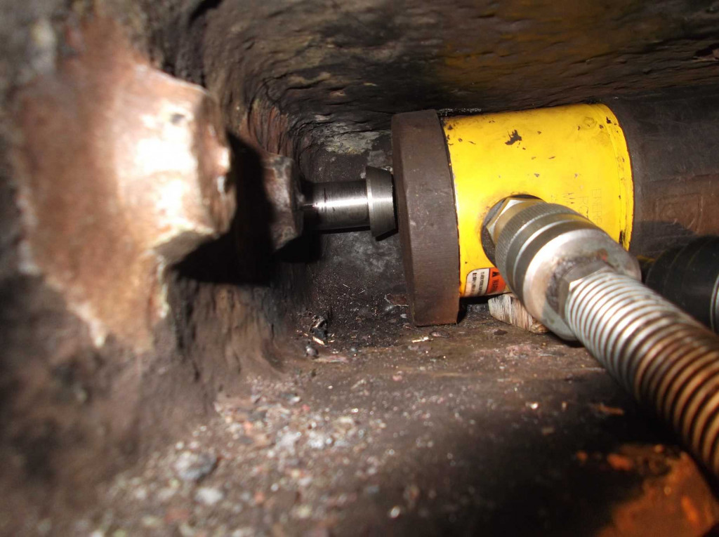 One of the new dragbox fitted bolts being jacked in place. The access problems doing repairs around the loco can be seen. Between overhauls there will be little chance to access this space. The hole the bolt is being forced in to has previously been reamed by hand and the surface under the bolt head faced to provide a good seat to the bolt head.