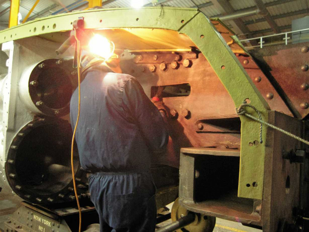 The outside of the front section of frames have been inspected and receive a last prep by Alan Pitt before painting.