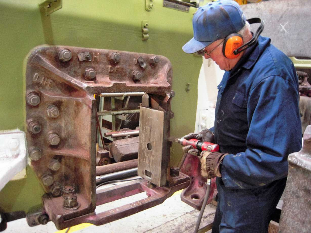 A tested hornstay casting is given a final needle gun treatment before painting.