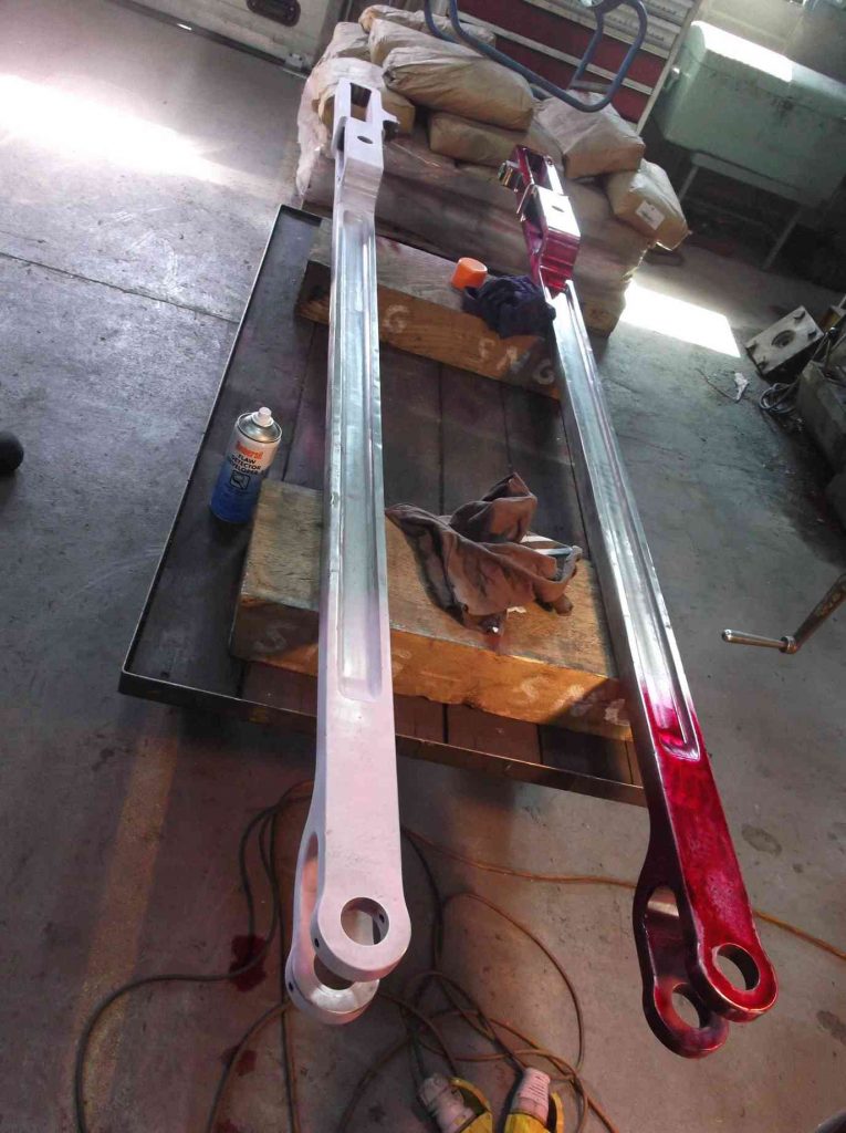 Radius rods being examined in the work shop.