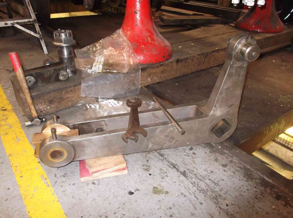Lifting arms from locomotive Sir Nigel Gresley on the workshop floor.