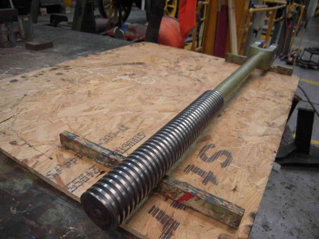 Reverser screw from locomotive Sir Nigel Gresley on a workshop bench.