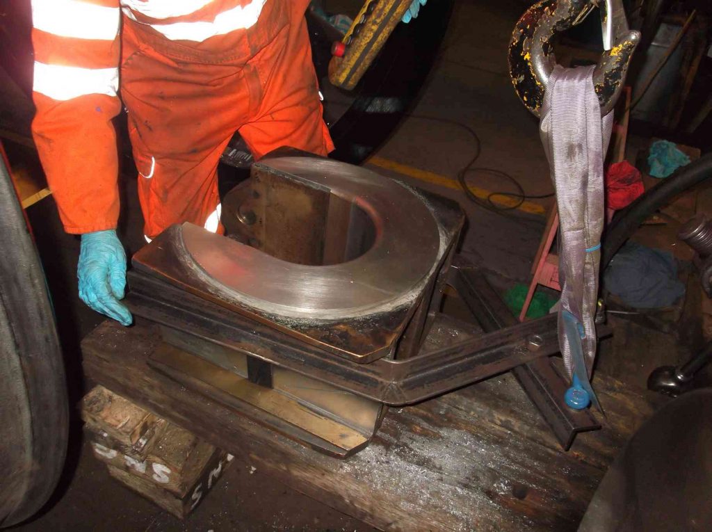 One of the axleboxes being scraped to its journal